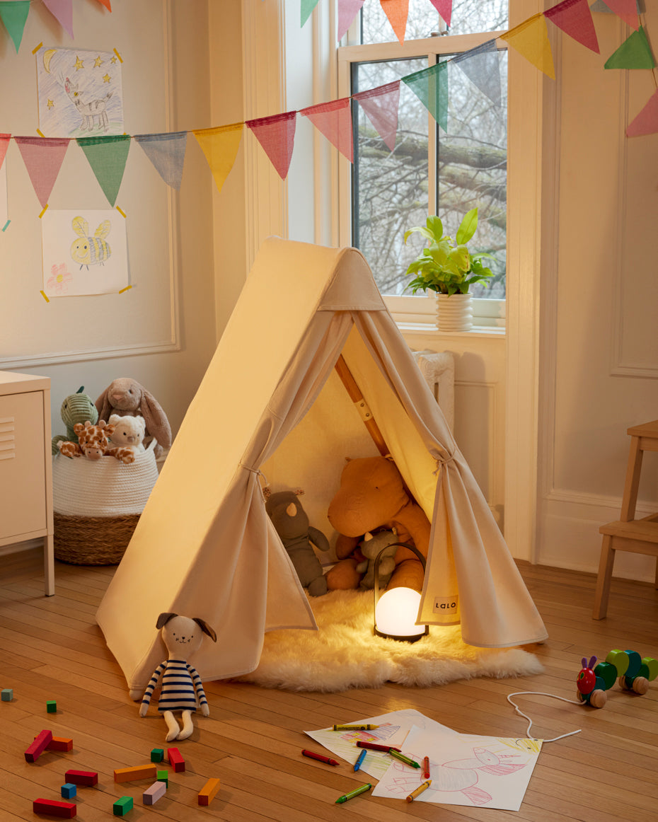 Neutral indoor play tent set up as a cozy reading nook